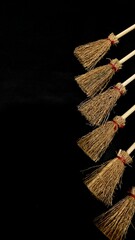 Mini witch brooms on black background, occult props, mystical composition, esoteric tools for magic and rituals