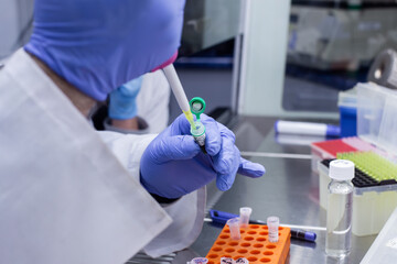 Genetic-molecular actions of a scientist in a laboratory, mixing molecular substances for cloning.