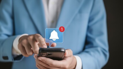 Person in blue suit using smartphone with notification bell icon and red alert
