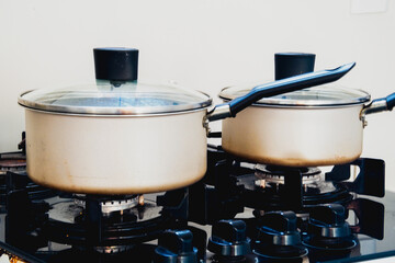 Two gray pots on a stove, close up