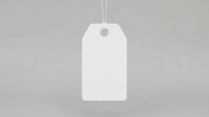 Blank white tag hanging on a string with a grey background, ready for customization