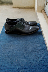 men's shoes at the front door, apartment door