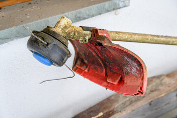 Detail of the rotating part of a string trimmer outside in winter.

