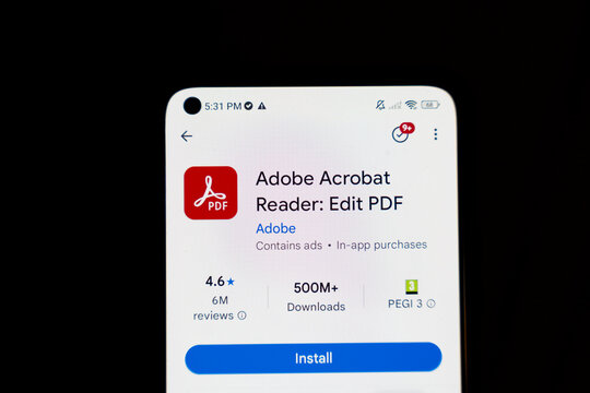 Warsaw, Poland - Dec 4, 2025: A close-up view of a mobile phone screen displaying the Adobe Acrobat Reader app, showcasing its interface for editing PDFs and user ratings.