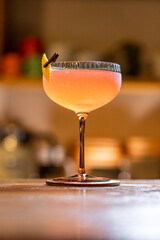 Pink cocktail served in a coupe glass