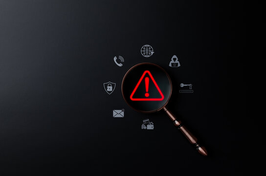 Cybersecurity threat detection concept. Magnifying glass on red alert symbol representing online risk, data breach, malware warning, scam, phishing, suspicious, unknown person, digital fraud awareness