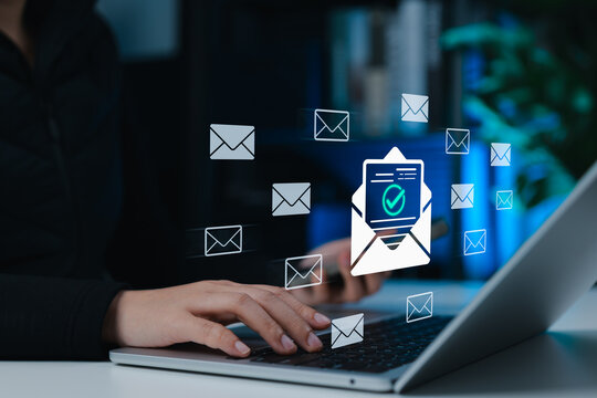 Verified email communication and digital messaging concept, showing a woman using laptop with multiple email icons and a confirmed email symbol, representing secure mail delivery and inbox management