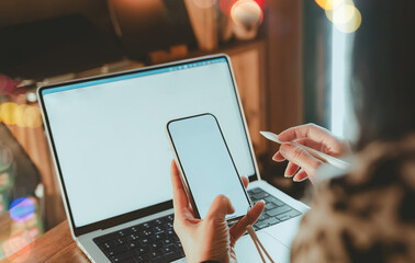 Business woman using smartphone,digital stylus pen working on laptop computer at home office,Cloes up hand woking  on blank screen mockup for remote work, digital marketing,app design,online business 