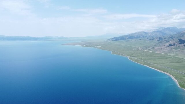 Aerial view of beautiful lake song kol kyrgyzstan with mountains and blue sky perfect for travel video