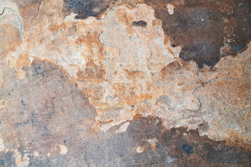 Obraz premium Abstract top-down view of natural slate stone texture with varied shades of orange, brown, and grey, perfect for a background.