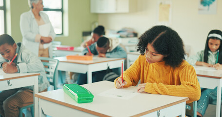 Obraz premium Student, girl and writing in classroom with test for education, learning and skill development. People, child or notes in school with pencil for exam, academic assignment and assessment solution.