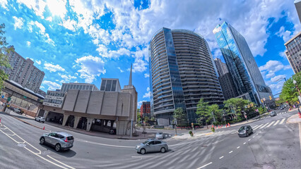 Low-angle view of Rosslyn, Virginia, skyscrapers reflecting a bright blue sky.