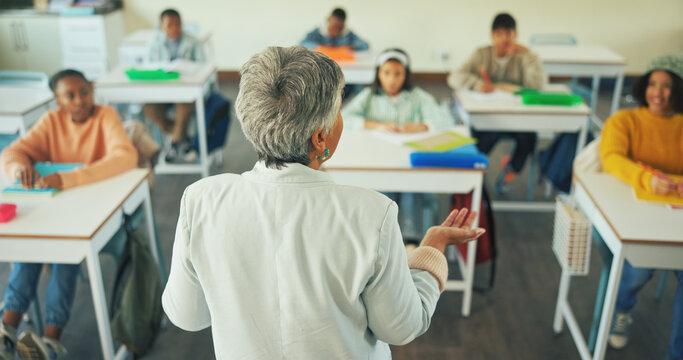 Teacher, presentation and education with children in classroom for students, quiz discussion and attention. Course guidance, speaker and problem solving solution with kids in school for lesson - Powered by Adobe