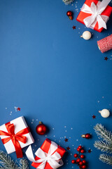 Fototapeta premium Red and white Christmas decorations and gifts on blue background.