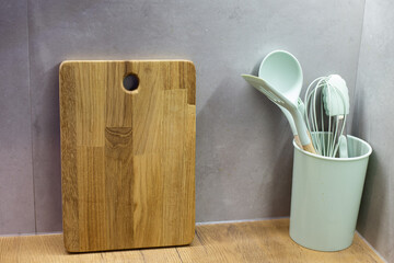 Green silicone kitchen utensils in a modern kitchen