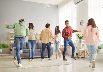 Happy dancing group fun, amuse, friends unity, diverse students team at home, people showing coomon support, active multinational cheerful best spend time together, enjoy life weekend, entertain