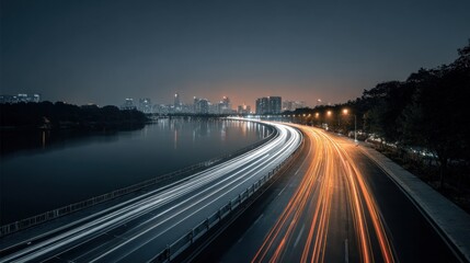 Fototapeta premium Night Cityscape with Light Trails on Road, Reflecting in River, showcasing urban transportation and motion