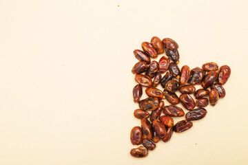 Dates forming heart on beige background for healthy love