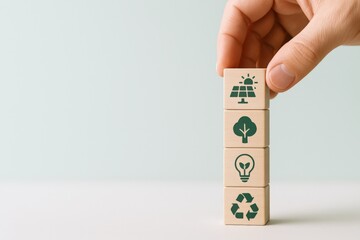 Sustainable Development Concept: Hand Stacking Wooden Blocks with Environmental Icons for Green Energy and Recycling