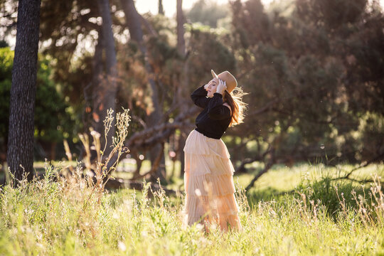 Pregnant woman enjoying nature in a sunlit meadow