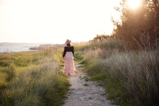 Serene woman walking in nature's sunset