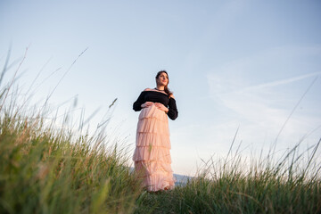 Serene moment with pregnant woman in nature