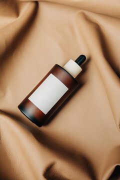 Vintage cosmetic bottle on fabric background