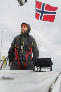 Sailor on a boat in the Norwegian sea with a flag