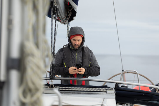 Focused sailor navigating the sea in Norwegian fiords