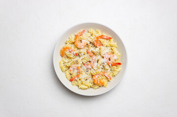 Pasta in a creamy sauce with shrimp and cheese. Italian cuisine.