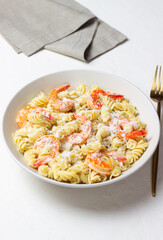 Pasta in a creamy sauce with shrimp and cheese. Italian cuisine.