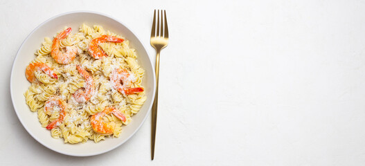 Pasta in a creamy sauce with shrimp and cheese. Italian cuisine.
