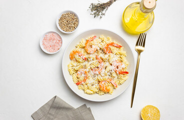 Pasta in a creamy sauce with shrimp and cheese. Italian cuisine.