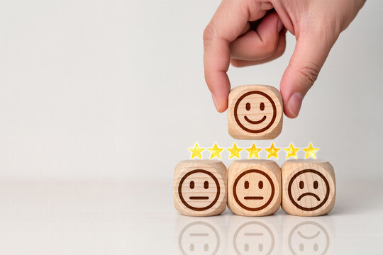 customer services best excellent business rating experience. Satisfaction survey concept. Hand of a businessman chooses a smile face on wood block circle. 5 Star Satisfaction