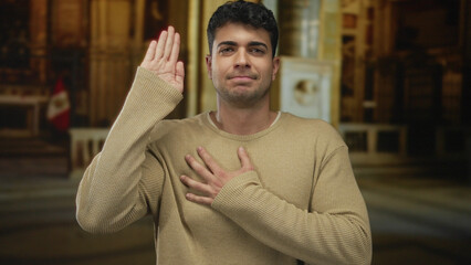 Man places hand and swears inside church as guy young hispanic takes oath in interior vow.