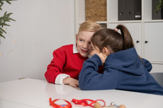 Children sharing secrets at Christmas time - Powered by Adobe