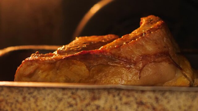 close-up of a piece of meat frying on a baking sheet in the oven, appetizing piece of meat being cooked in the kitchen, meat delicacies preparation