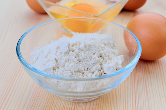 Eggs and flour arranged for baking preparation