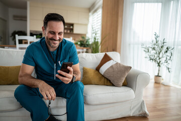 Male healthcare worker relaxing at home using phone