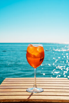 Refreshing aperol spritz by the sea on a sunny day