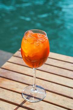 Refreshing aperol spritz cocktail by the water