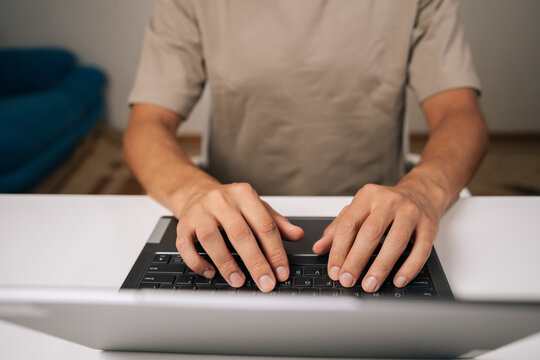 Close-up top view of programmer male hands typing code on laptop keyboard, showcasing process of software development and coding expertise. Concept of remote workplace. - Powered by Adobe