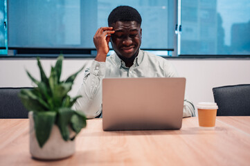 Stressed businessman struggling with work burnout and headache
