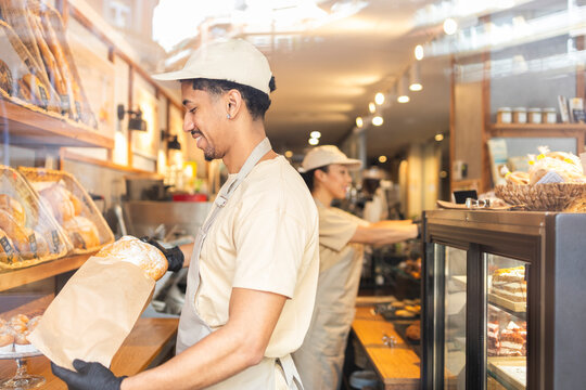 Bakery workers preparing fresh bread and pastries