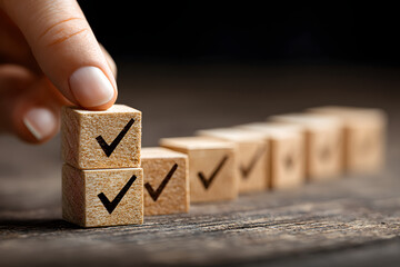 Checklist and task progress tracking concept. A hand placing the final checkmark on wooden blocks in a progress bar, task completion, productivity, goal setting, and efficient project management.