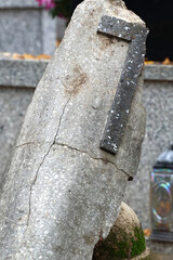 Broken Stone Cross on Weathered Ground
