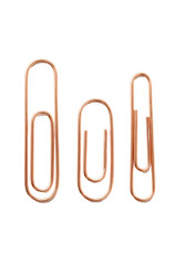 Three minimalist rose gold copper paper clips on a transparent background with crisp reflections and shadows. Concept of luxury minimalist office supplies