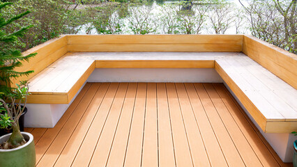 Modern wooden deck seating area and built-in bench in a minimalist outdoor garden with natural...