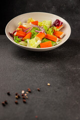 Crab sticks salad green salad leaves healthy food appetizer fresh gourmet food table setting rustic food top view copy space keto and paleo diet