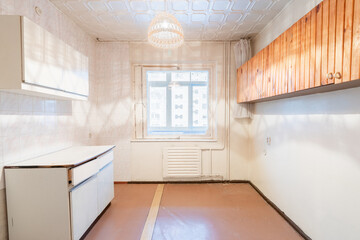 Old Kitchen Interior with White Cabinets and Brightly Lit Space. Old Retro Soviet Style Home...